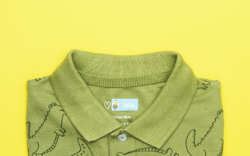 groen poloshirt met My Nametags-sticker erop, op een gele achtergrond